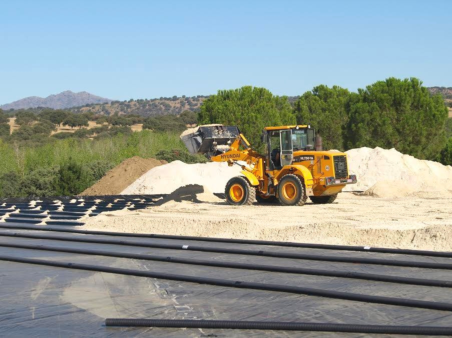 Excavator working on construction site – preparing foundation for Risohorse arena
